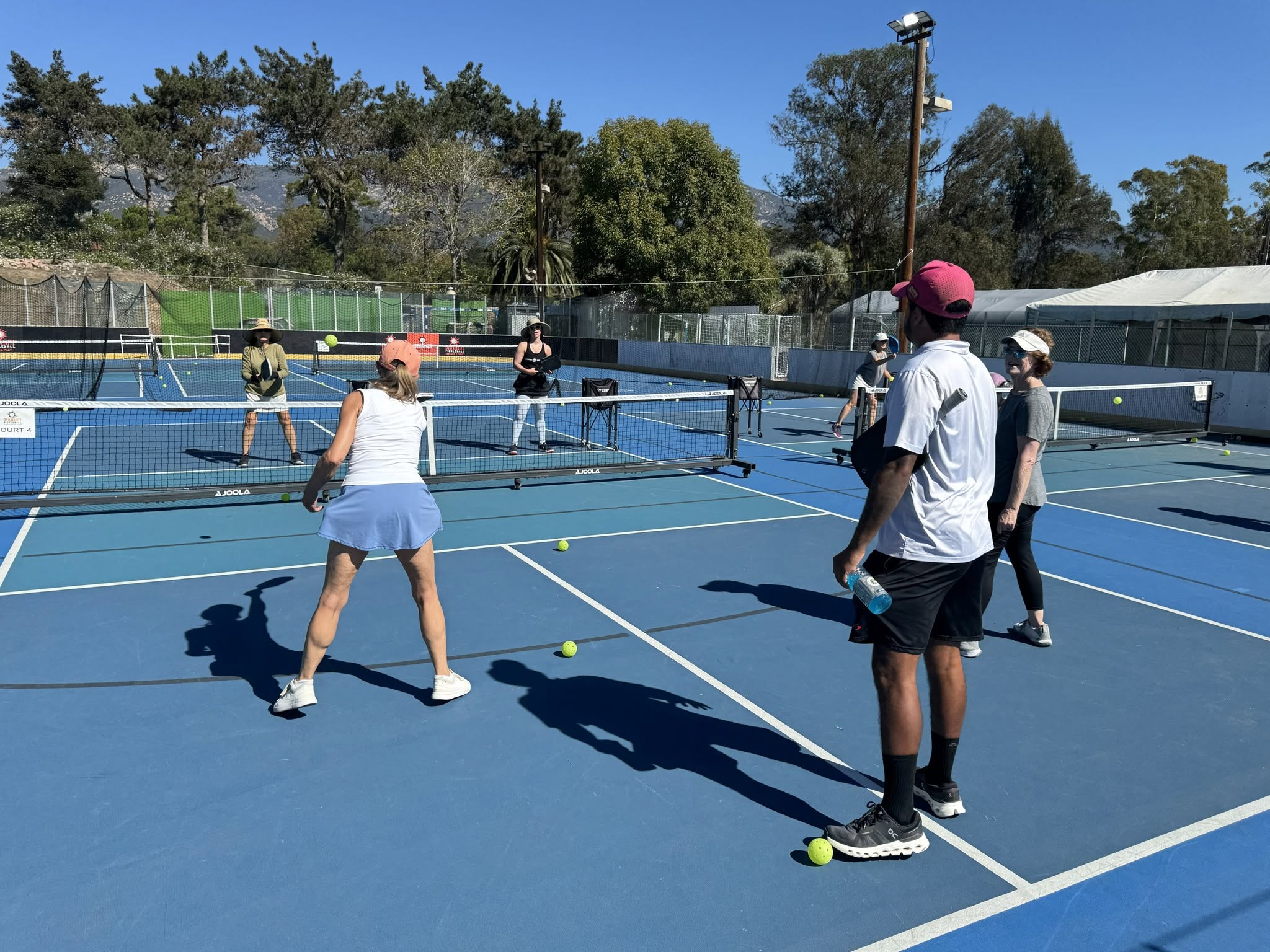 Players running a doubles drill at a pickleball clinic at Dynamite Pickleball in Santa Barbara